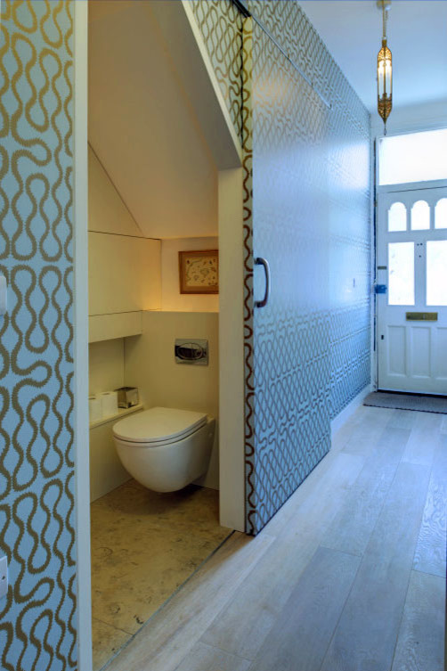 Example of a small trendy powder room design in London