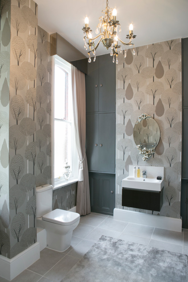 Inspiration for a large timeless gray tile powder room remodel in Dorset with gray cabinets and marble countertops