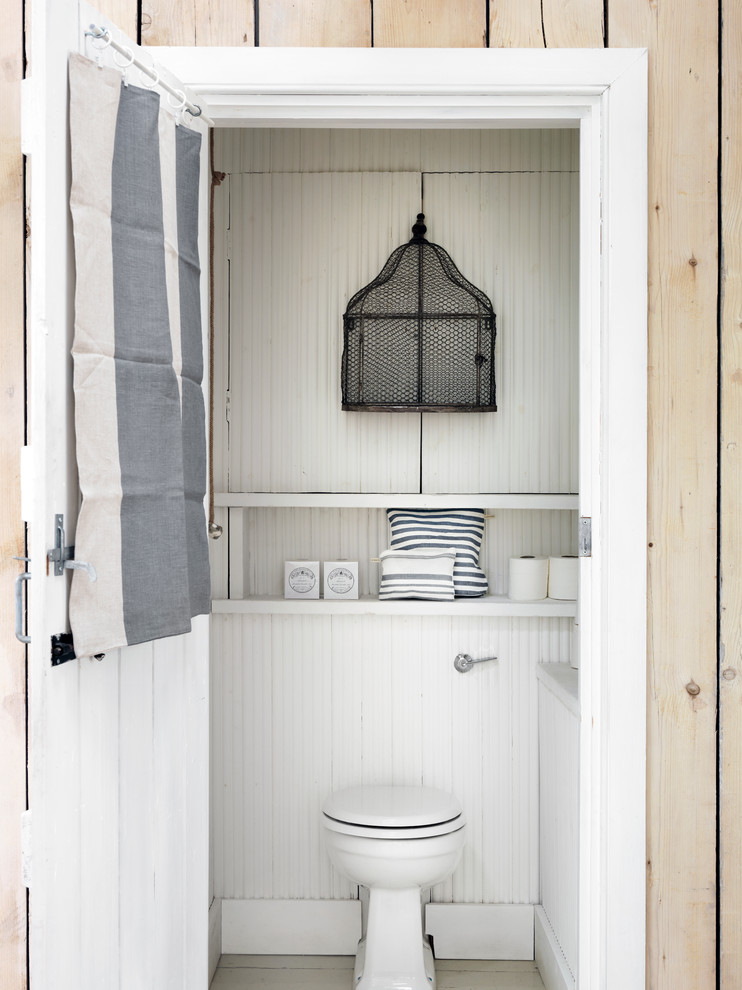Inspiration for a beach style cloakroom in London with white walls.