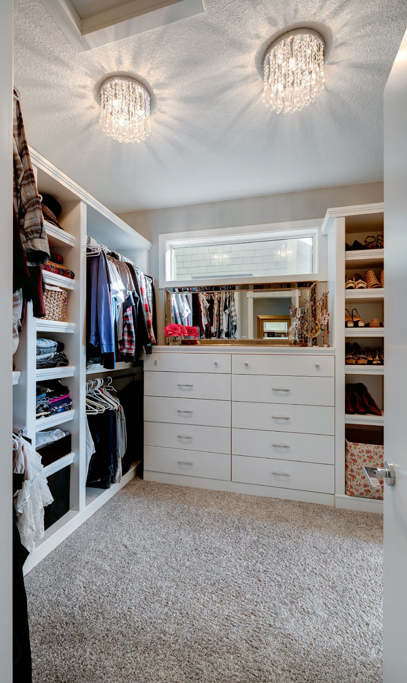 Inspiration for a medium sized classic gender neutral walk-in wardrobe in Calgary with white cabinets and carpet.