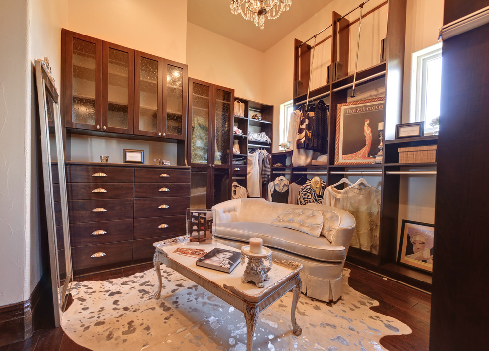 Dressing room - large mediterranean women's medium tone wood floor dressing room idea in Austin with dark wood cabinets