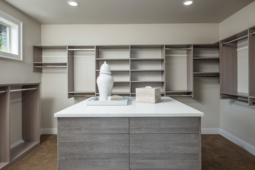 Contemporary walk-in wardrobe in Seattle with flat-panel cabinets.