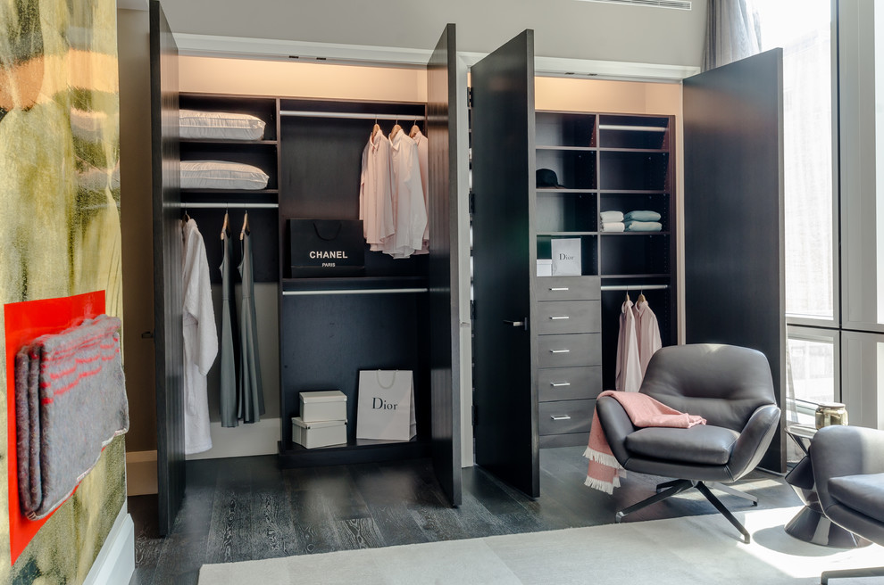 Huge trendy gender-neutral gray floor reach-in closet photo in New York with open cabinets and dark wood cabinets