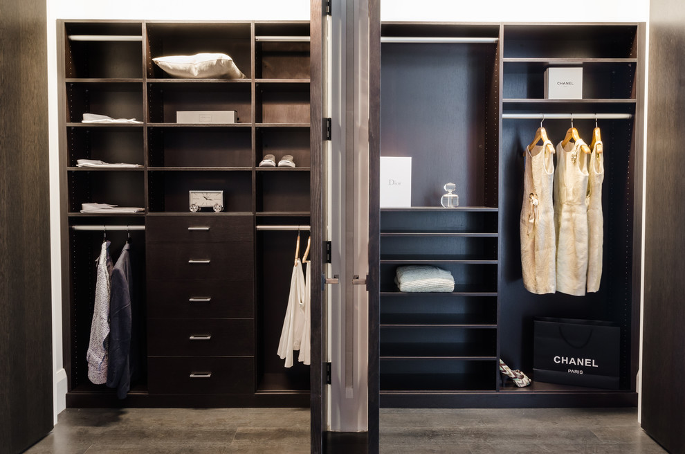 Example of a huge trendy gender-neutral gray floor reach-in closet design in New York with open cabinets and dark wood cabinets
