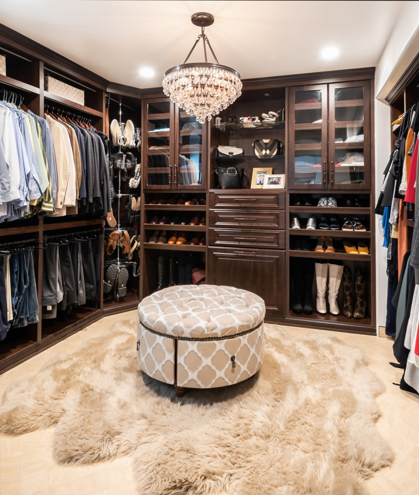 Inspiration for a medium sized gender neutral walk-in wardrobe in Los Angeles with raised-panel cabinets, dark wood cabinets, ceramic flooring and beige floors.