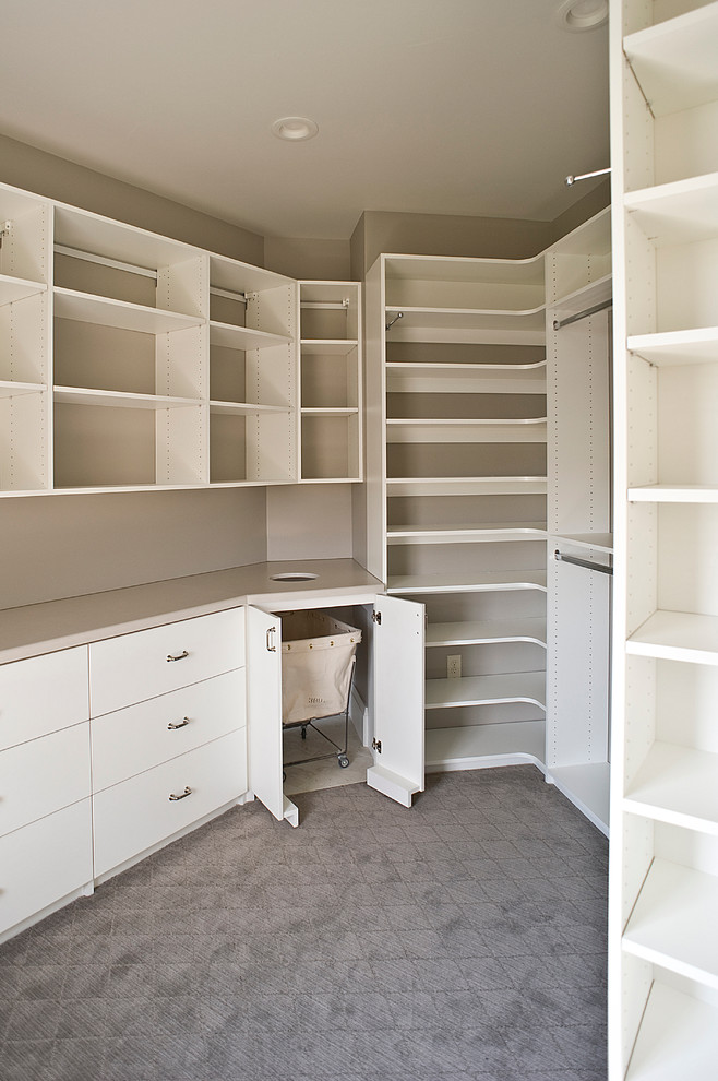 Inspiration for a large classic gender neutral walk-in wardrobe in Other with flat-panel cabinets, white cabinets and carpet.