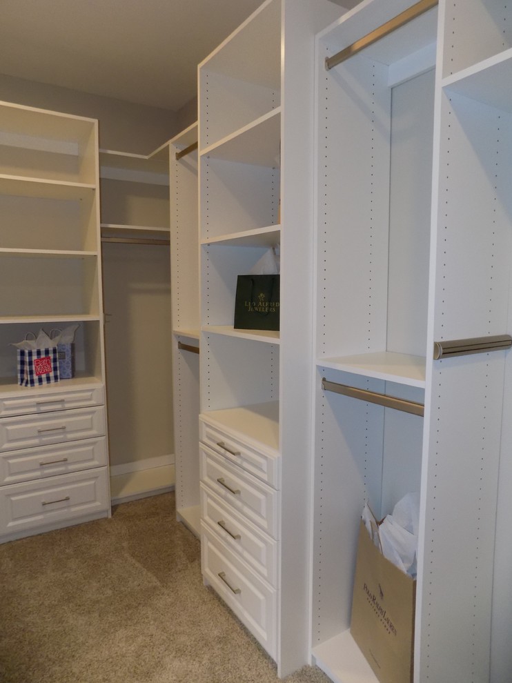 Inspiration for a large craftsman gender-neutral carpeted and beige floor walk-in closet remodel in Columbus with raised-panel cabinets and white cabinets