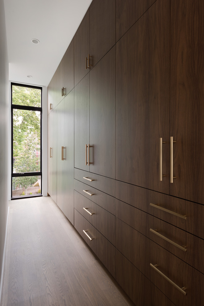 Réalisation d'un dressing minimaliste en bois brun de taille moyenne et neutre avec un placard à porte plane, parquet clair et un sol gris.