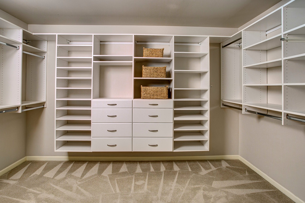 Example of a large arts and crafts gender-neutral carpeted dressing room design in Seattle with flat-panel cabinets and white cabinets