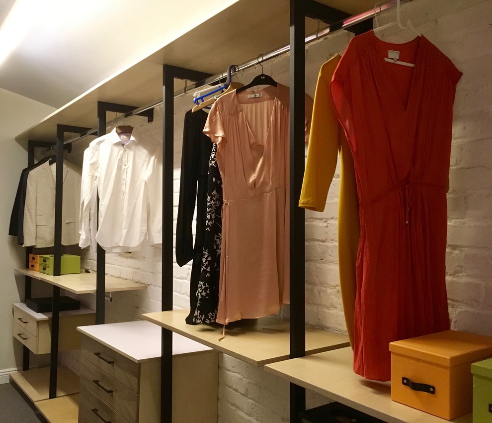 Photo of a medium sized industrial gender neutral walk-in wardrobe in Other with carpet, grey floors, open cabinets and light wood cabinets.
