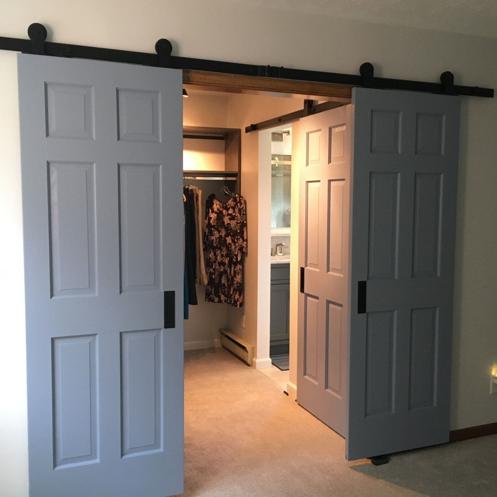 Inspiration for a mid-sized cottage gender-neutral carpeted and beige floor walk-in closet remodel in Other with flat-panel cabinets and gray cabinets