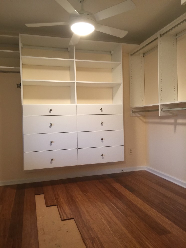 Photo of a medium sized classic gender neutral walk-in wardrobe in Charlotte with flat-panel cabinets, white cabinets, dark hardwood flooring and brown floors.