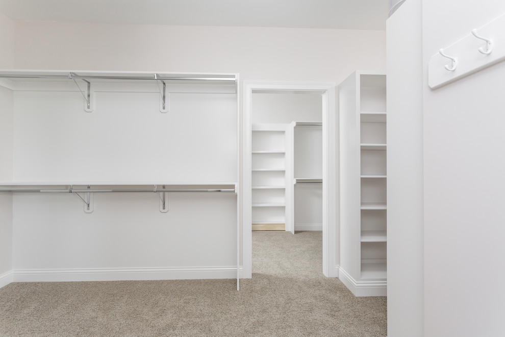 Huge arts and crafts gender-neutral carpeted walk-in closet photo in Indianapolis with open cabinets and white cabinets