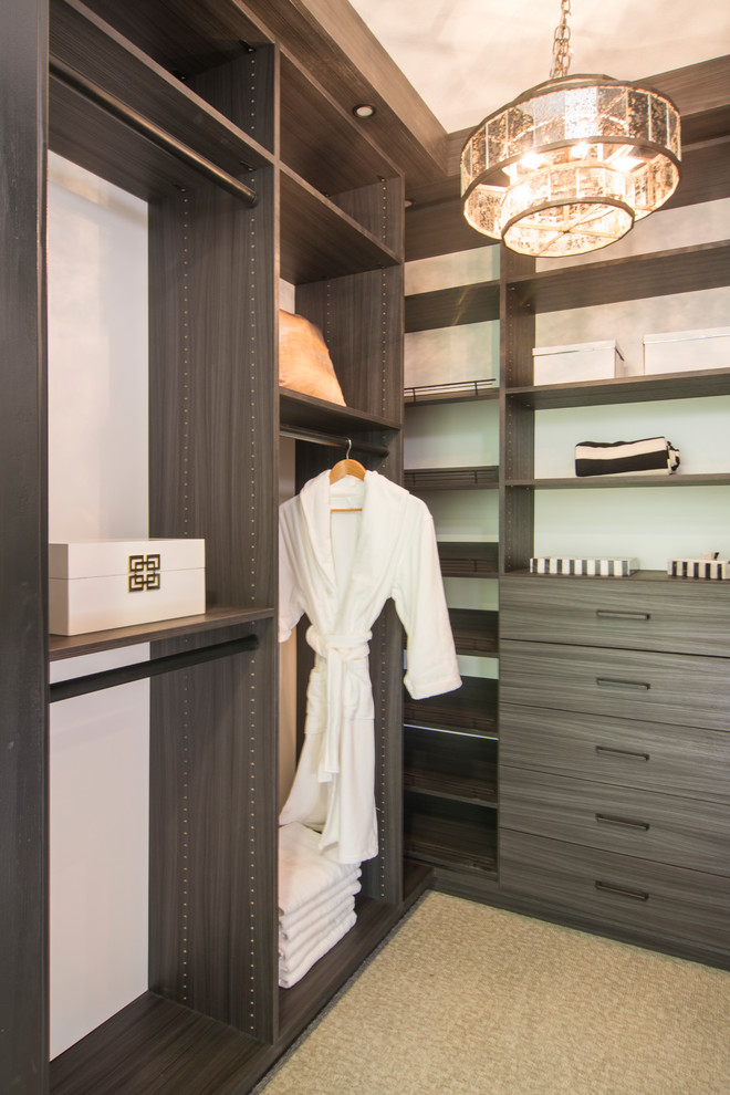Contemporary walk-in wardrobe in San Francisco with flat-panel cabinets and dark wood cabinets.