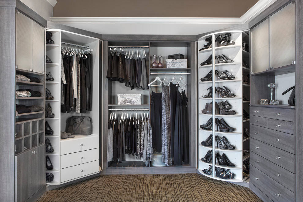 Example of a transitional gender-neutral walk-in closet design in Chicago with open cabinets and gray cabinets