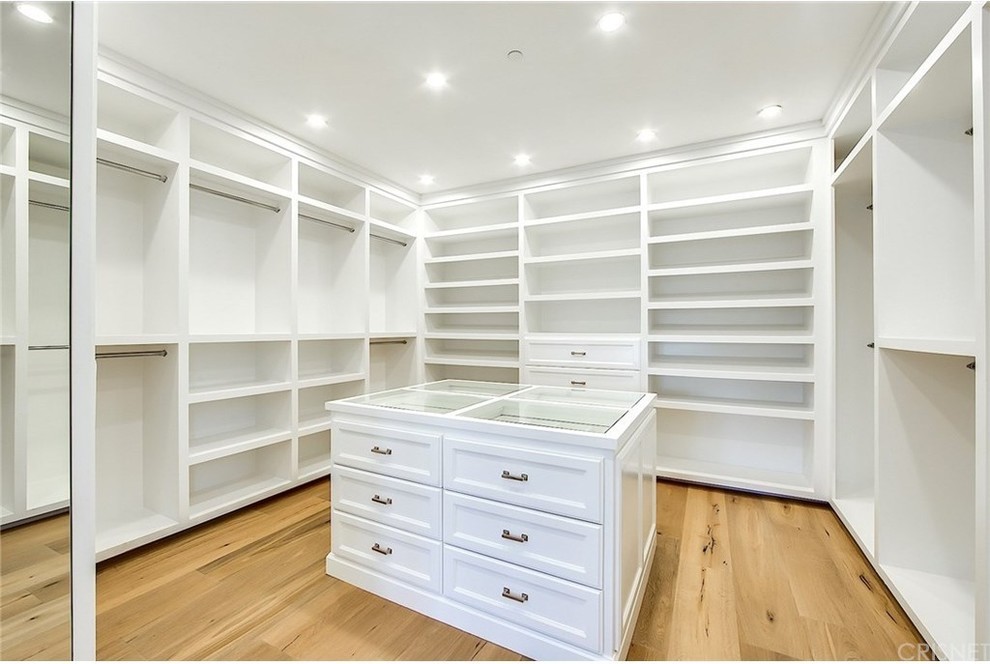 Huge country gender-neutral walk-in closet photo in Los Angeles with flat-panel cabinets and white cabinets