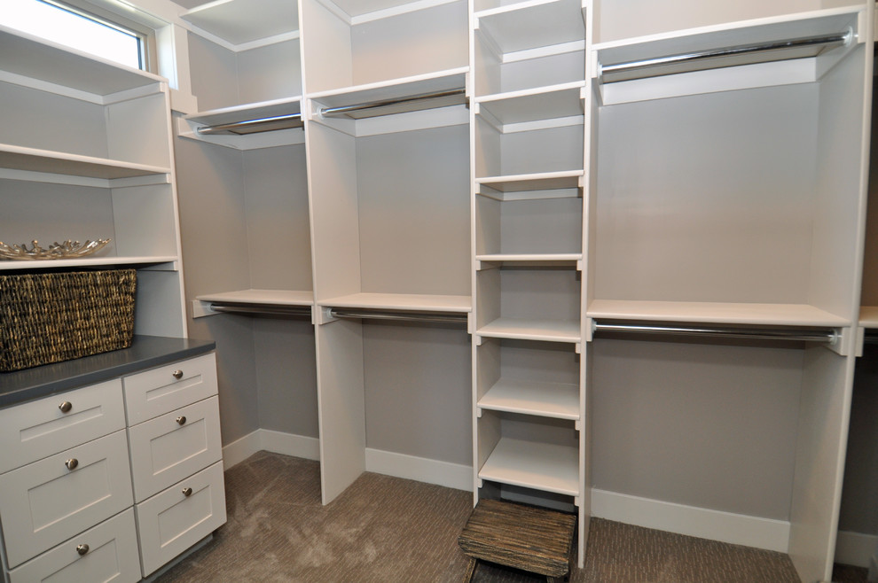 Inspiration for a mid-sized transitional gender-neutral carpeted walk-in closet remodel in Other with shaker cabinets and white cabinets