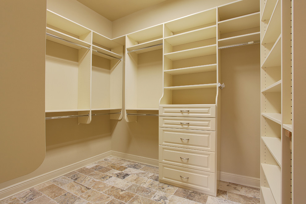 Elegant gender-neutral ceramic tile walk-in closet photo in New Orleans with raised-panel cabinets and white cabinets