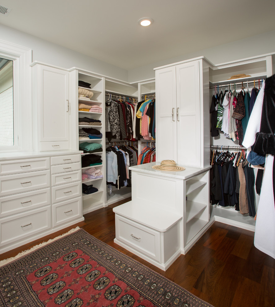 На фото: гардеробная комната в классическом стиле с белыми фасадами и паркетным полом среднего тона