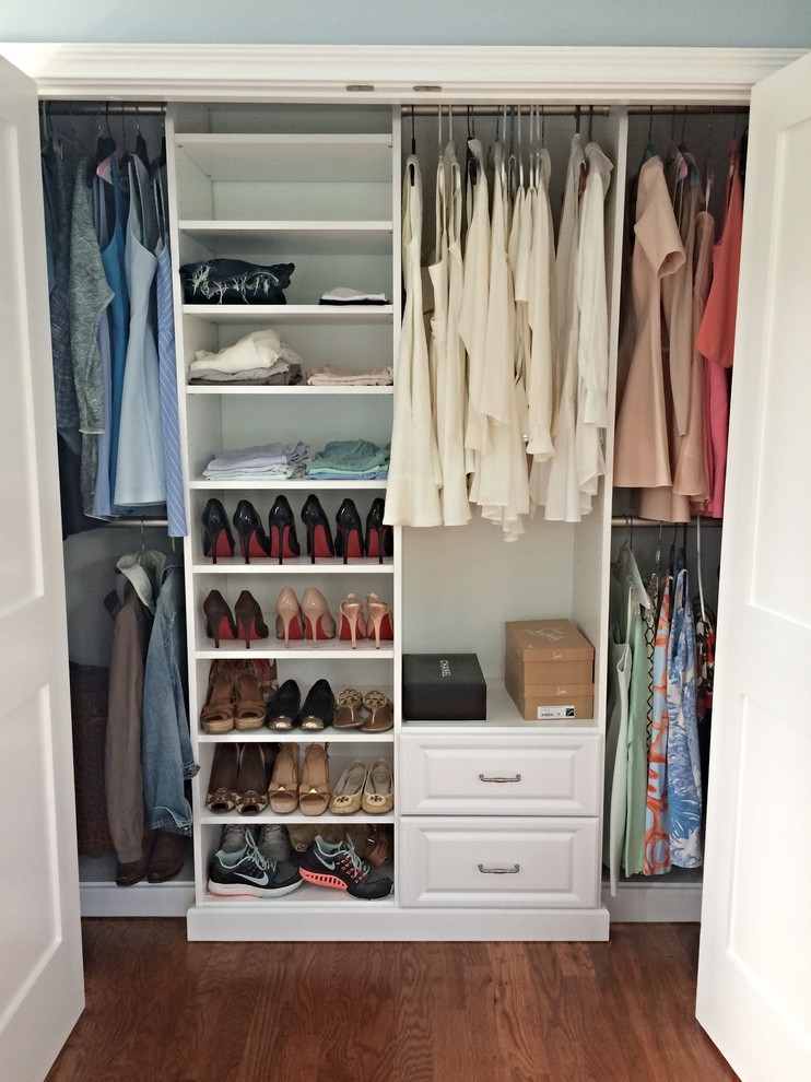 Small classic standard wardrobe for women in DC Metro with raised-panel cabinets, white cabinets, medium hardwood flooring and brown floors.