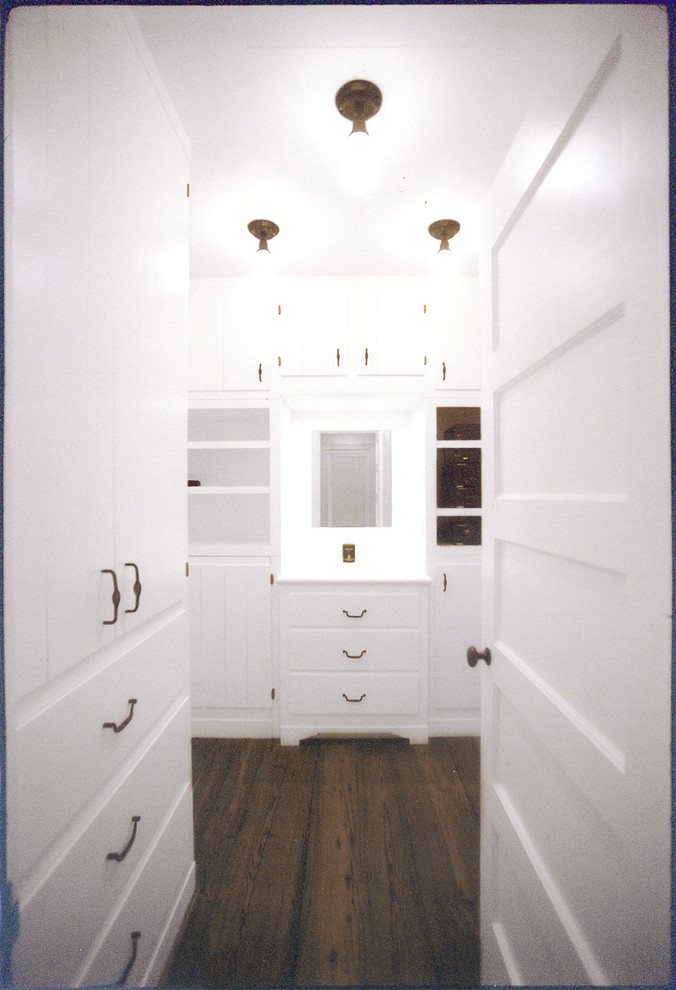 Walk-in closet - mid-sized cottage men's dark wood floor walk-in closet idea in New York with recessed-panel cabinets and white cabinets