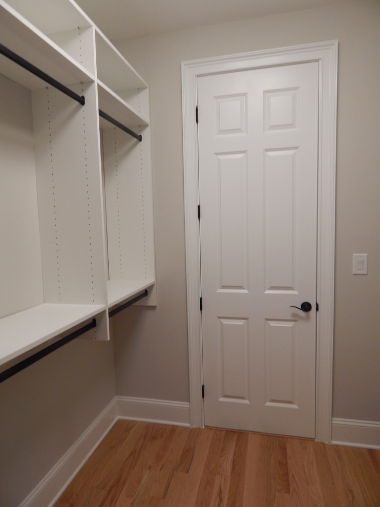 Design ideas for a large classic wardrobe in Charlotte with raised-panel cabinets and white cabinets.