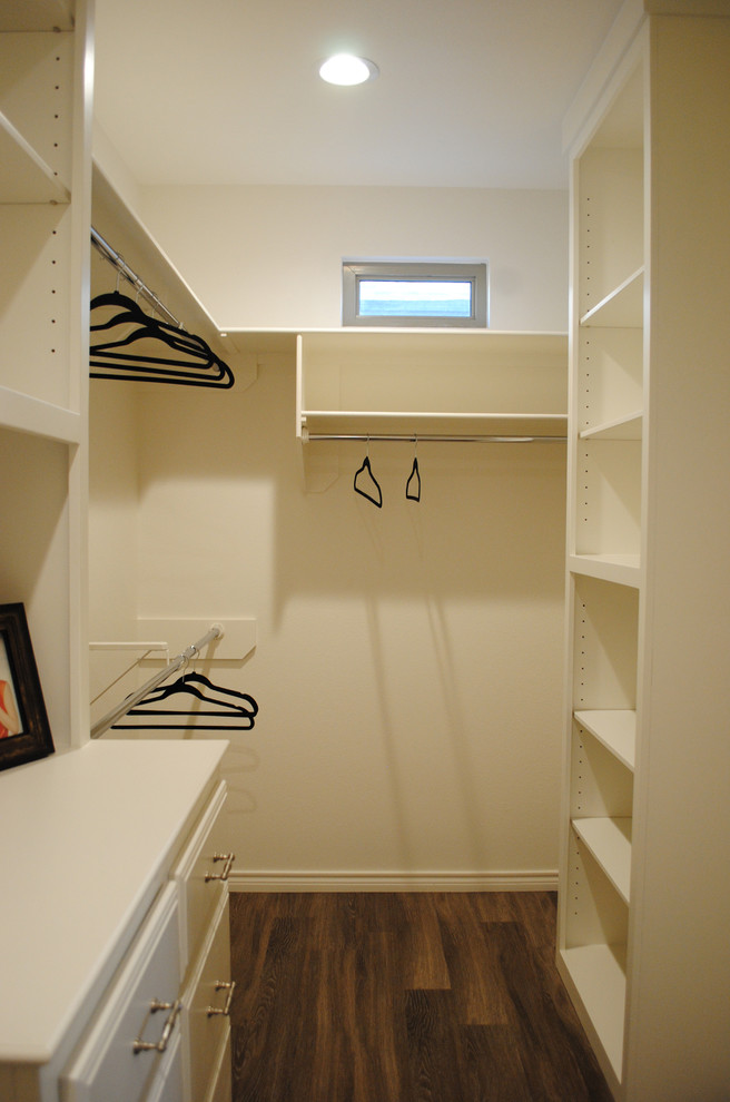 Bild på ett stort eklektiskt walk-in-closet för könsneutrala, med släta luckor, vita skåp och vinylgolv