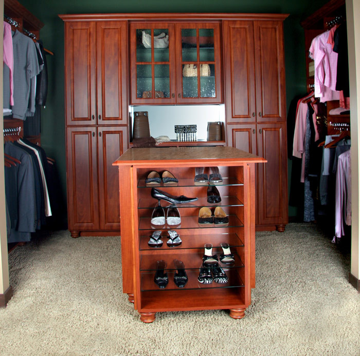 Ejemplo de armario vestidor unisex tradicional de tamaño medio con armarios con paneles con relieve, puertas de armario de madera en tonos medios, moqueta y suelo beige