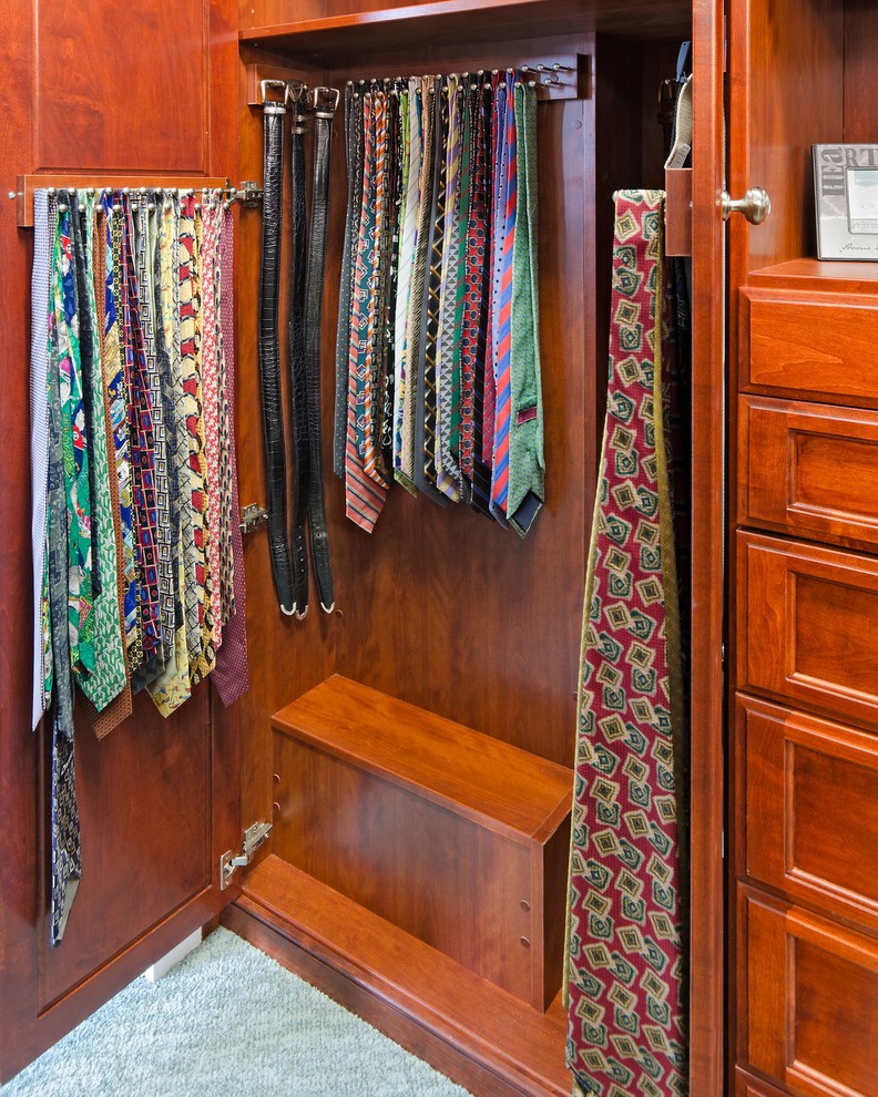Large transitional men's carpeted walk-in closet photo in Los Angeles with medium tone wood cabinets and recessed-panel cabinets
