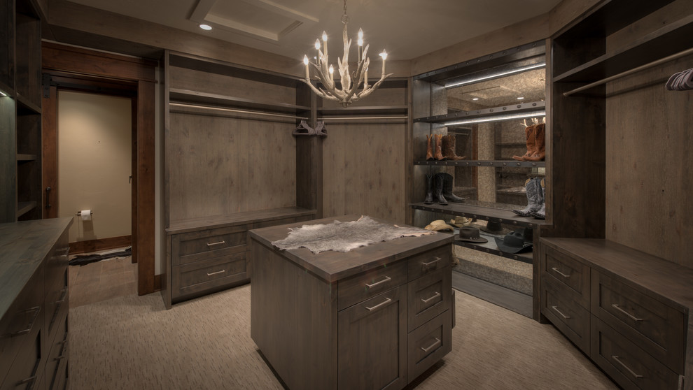 Inspiration for a large rustic carpeted walk-in closet remodel in Denver with flat-panel cabinets and gray cabinets