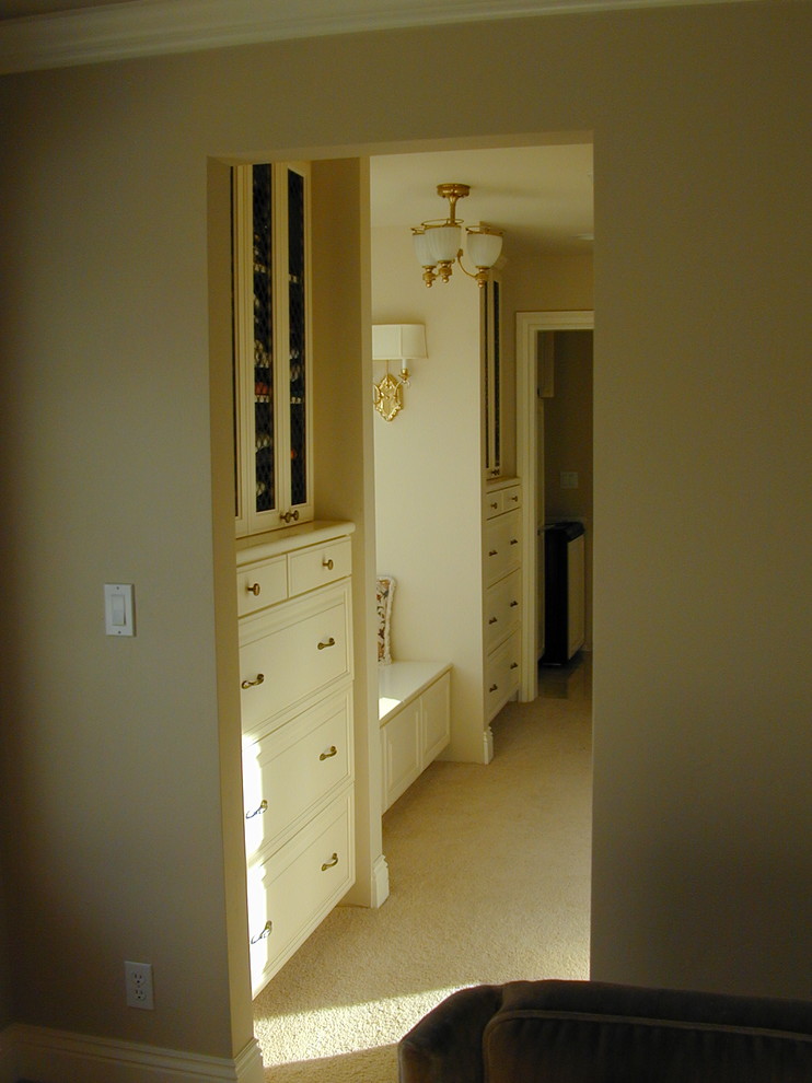 Cette photo montre un dressing room chic de taille moyenne et neutre avec un placard avec porte à panneau surélevé, des portes de placard blanches et moquette.