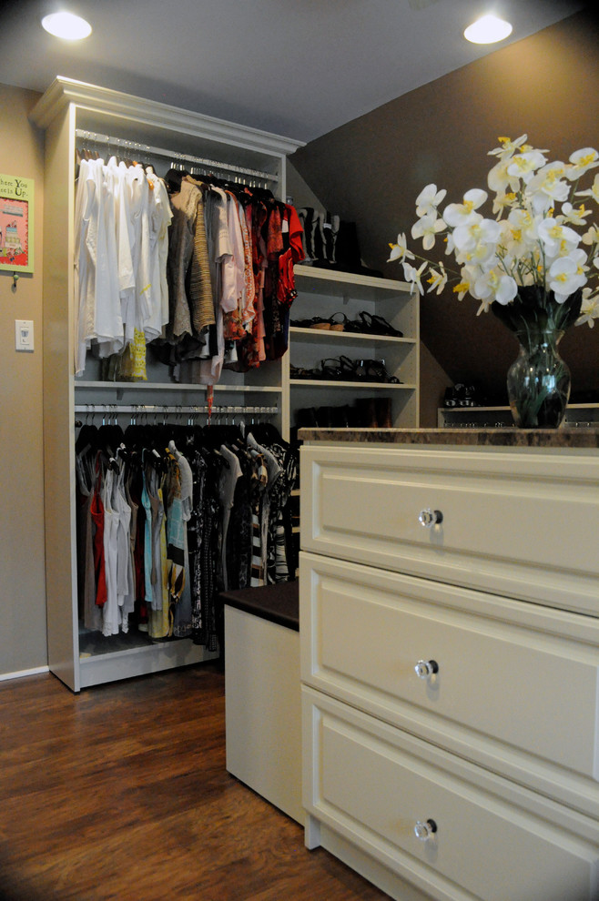 Inspiration for a large timeless women's dressing room remodel in Philadelphia with raised-panel cabinets and beige cabinets