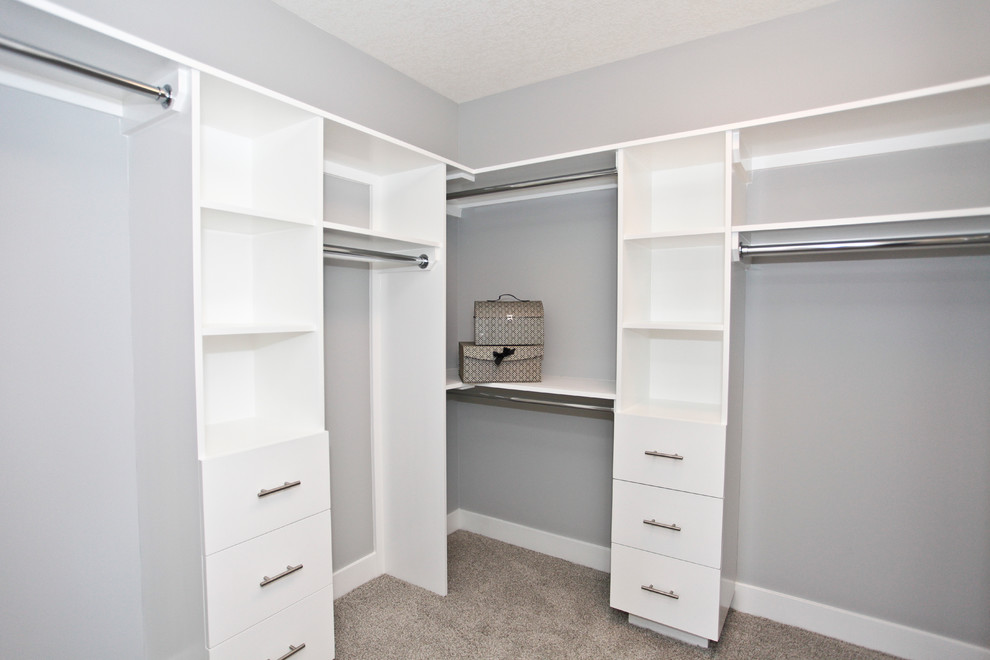 Inspiration for a mid-sized timeless women's carpeted walk-in closet remodel in Calgary with open cabinets and white cabinets