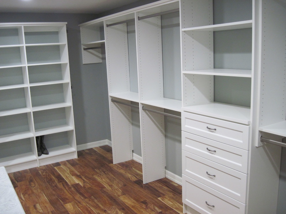 Photo of a medium sized traditional gender neutral walk-in wardrobe in Other with open cabinets, white cabinets and dark hardwood flooring.