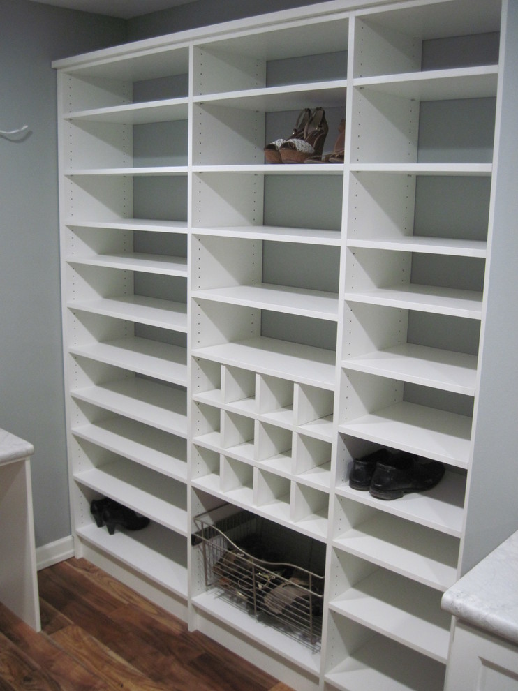 Mid-sized elegant gender-neutral dark wood floor walk-in closet photo in Other with open cabinets and white cabinets