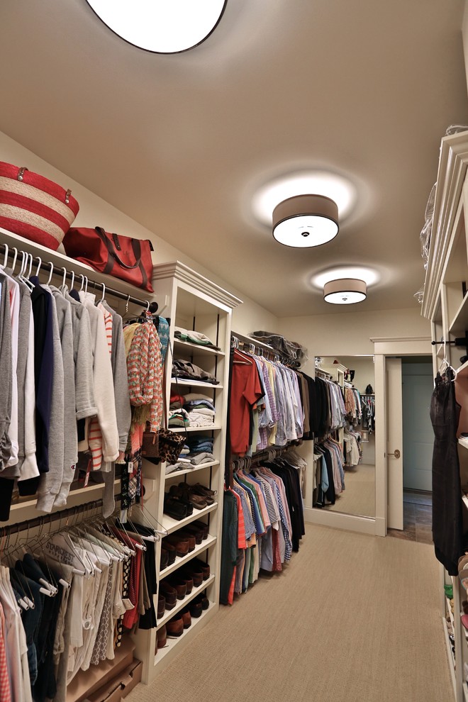 Example of a large classic gender-neutral carpeted walk-in closet design in Chicago with open cabinets and white cabinets