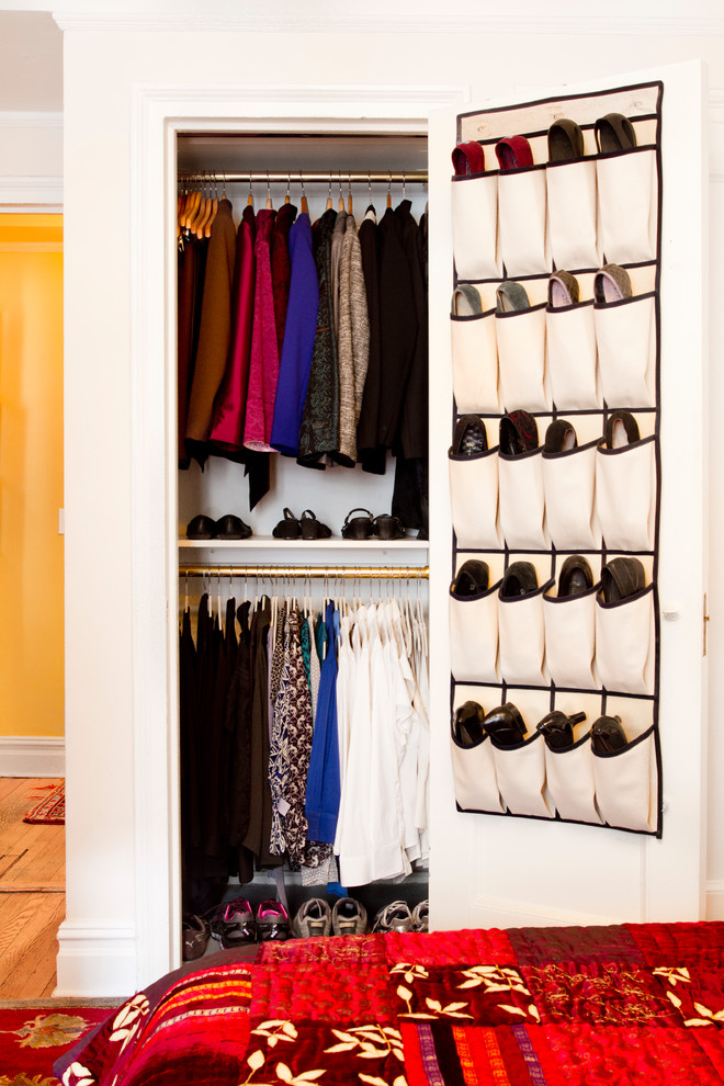 Reach-in closet - small traditional gender-neutral medium tone wood floor and brown floor reach-in closet idea in New York