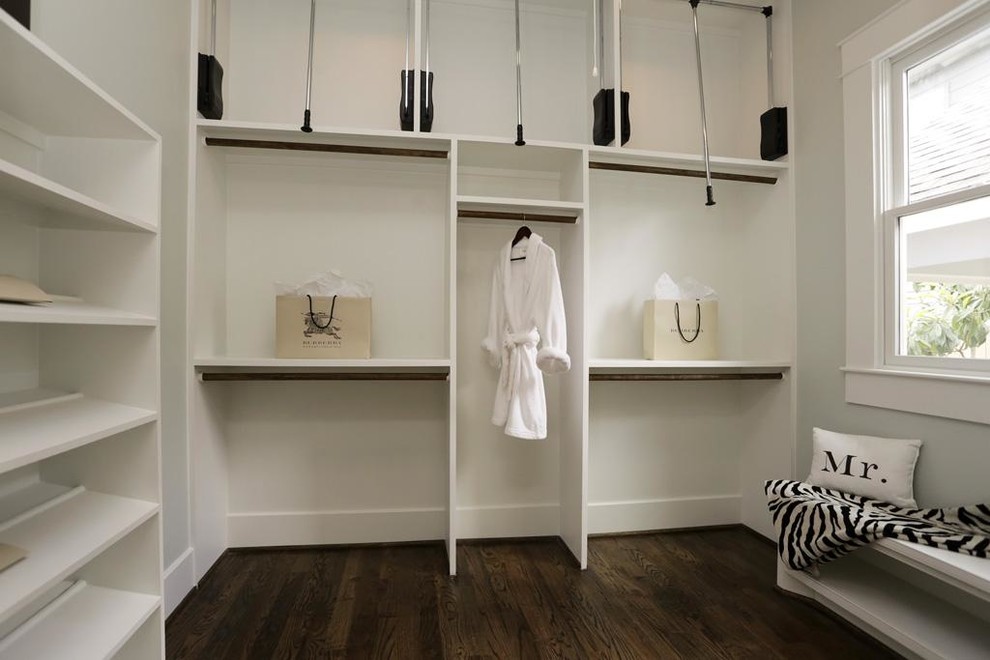 Example of a small classic gender-neutral medium tone wood floor dressing room design in Denver with open cabinets and white cabinets
