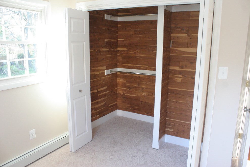 This is an example of a small modern gender neutral dressing room in Baltimore with carpet.