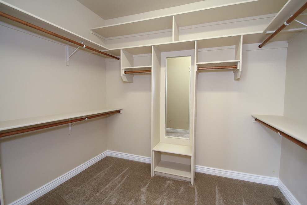 Example of a mid-sized arts and crafts gender-neutral carpeted walk-in closet design in Boise