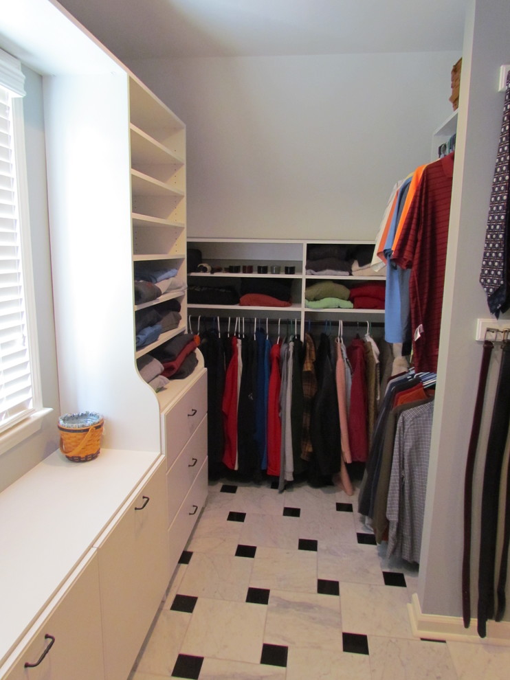 Walk-in closet - mid-sized transitional gender-neutral porcelain tile walk-in closet idea in Atlanta with flat-panel cabinets and white cabinets