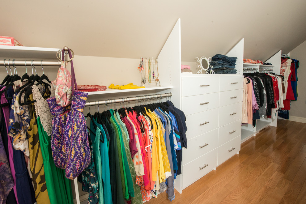 Photo of an expansive traditional walk-in wardrobe for women in Other with open cabinets, white cabinets and brown floors.