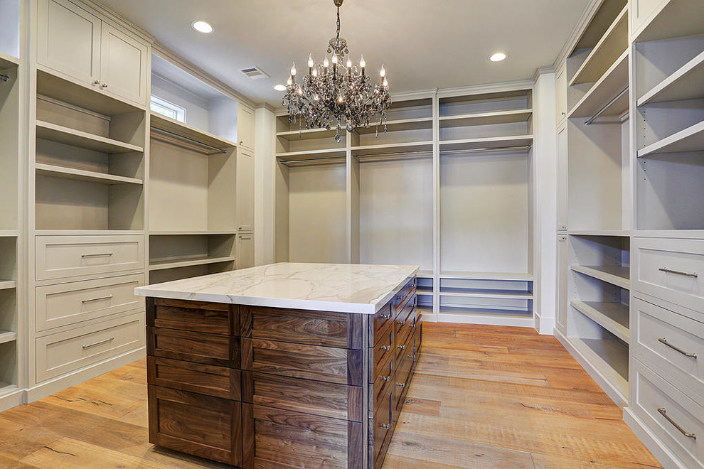 This is an example of an expansive traditional wardrobe in Houston.