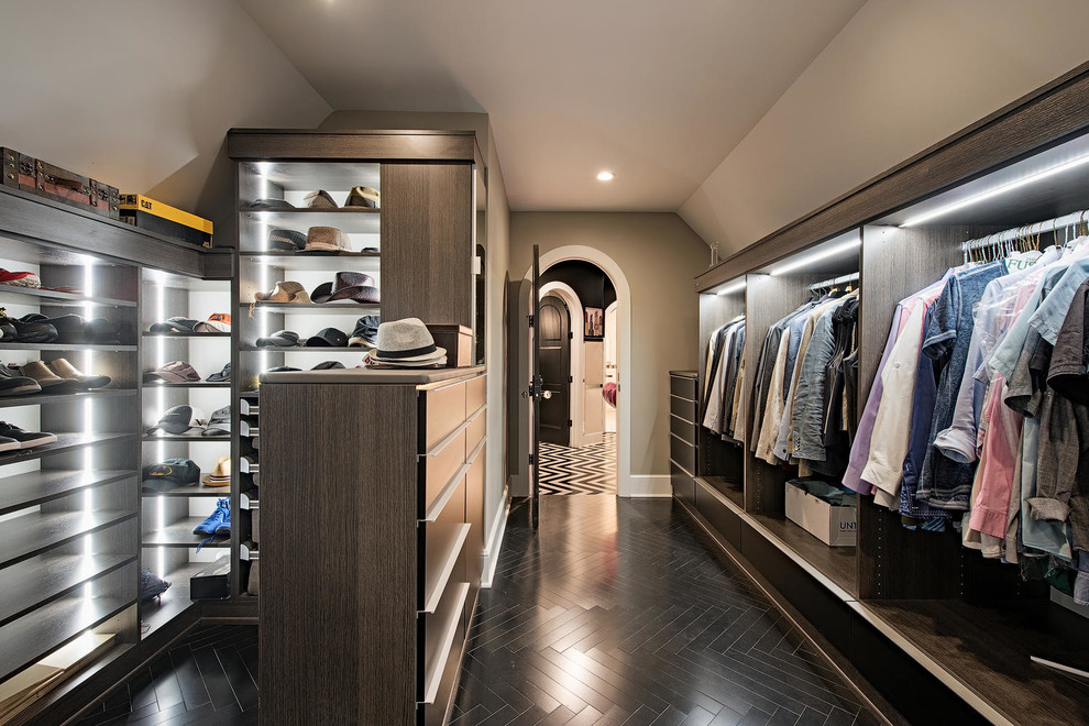 Large traditional walk-in wardrobe for men in Cleveland with open cabinets, dark wood cabinets, black floors and dark hardwood flooring.