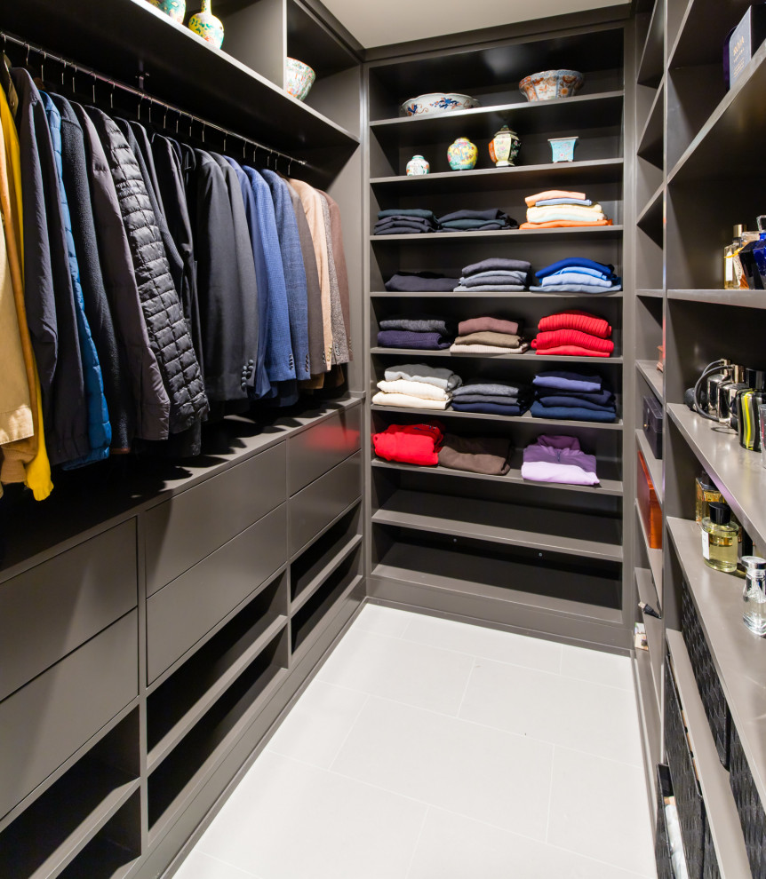 Example of a mid-sized minimalist gender-neutral porcelain tile and gray floor walk-in closet design in Dallas with flat-panel cabinets and gray cabinets
