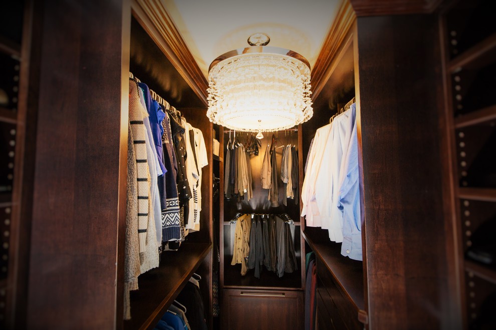 Small elegant walk-in closet photo in Other with flat-panel cabinets and dark wood cabinets