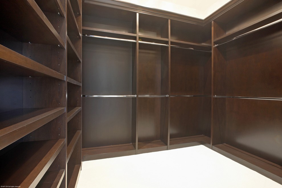 Inspiration for an expansive mediterranean walk-in wardrobe for men in Miami with carpet.