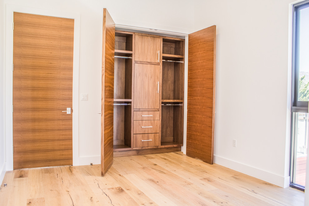 Foto de armario unisex contemporáneo de tamaño medio con armarios con paneles lisos, puertas de armario de madera oscura, suelo de madera clara y suelo marrón