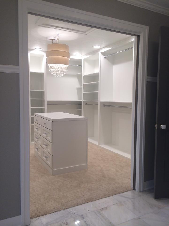 Dressing room - mid-sized transitional women's carpeted dressing room idea in Other with white cabinets and recessed-panel cabinets