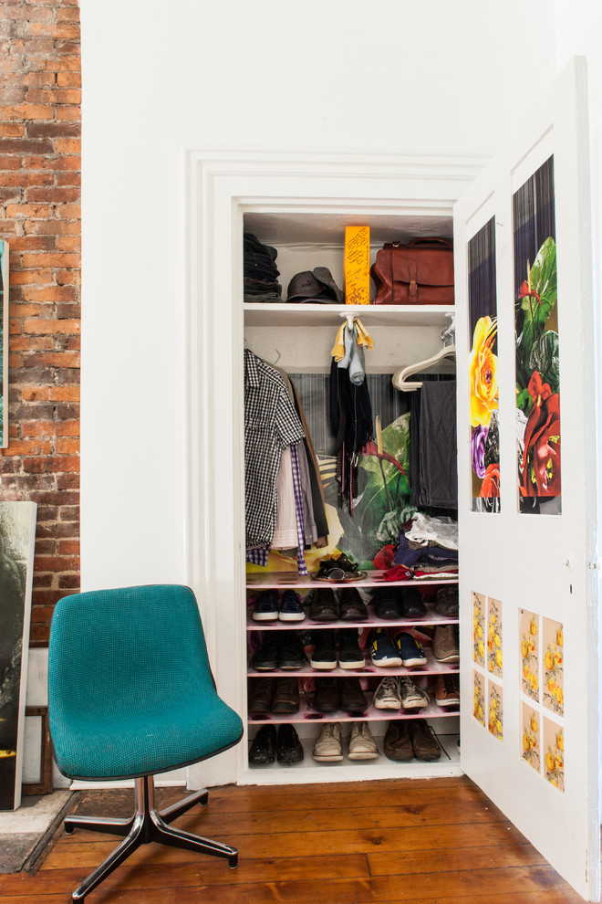 Example of an eclectic reach-in closet design in Other with open cabinets and white cabinets